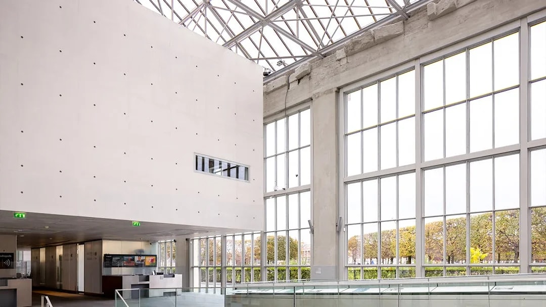 Spacious Orangerie interior with large windows and modern design.