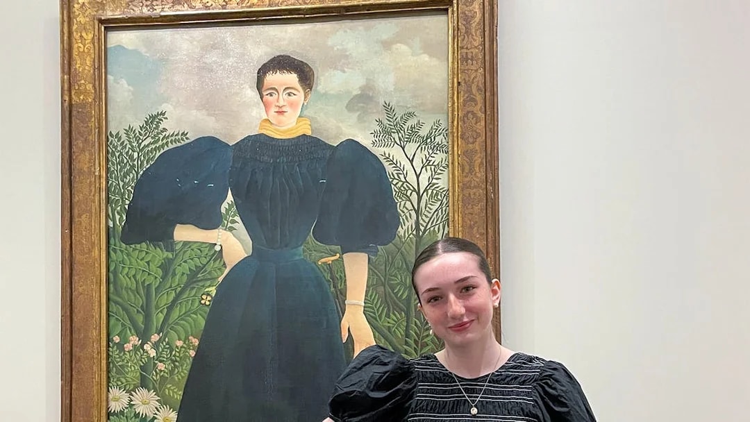 Painting at Orangerie Museum with visitor standing nearby.