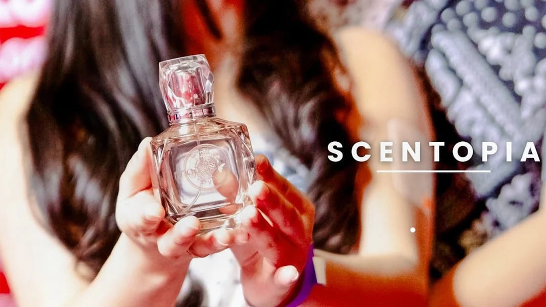 Tourist holding a perfume bottle at Scentopia Sentosa Singapore.
