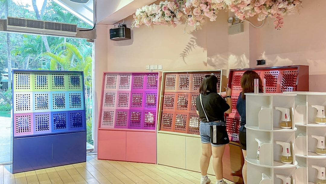 Visitors exploring fragrance displays at Scentopia Sentosa.