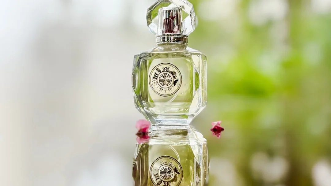 Premium perfume bottle Scentopia Sentosa Singapore with floral reflection.