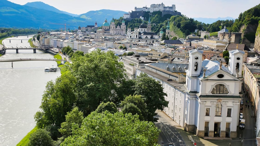 Salzburg cityscape with Hohensalzburg Fortress and Salzach River, view from Original Sound of Music Tour.