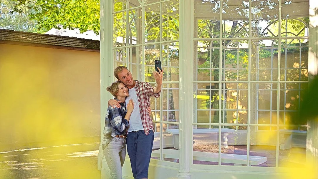 Couple taking a selfie at the gazebo from The Sound of Music tour in Salzburg.