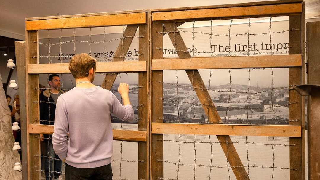 Visitor examining exhibit at Oskar Schindler’s Factory in Krakow.