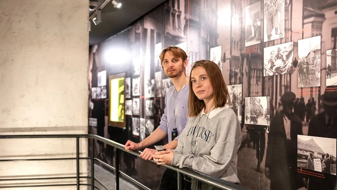 Couple exploring exhibits inside Oskar Schindler's Factory, Krakow.