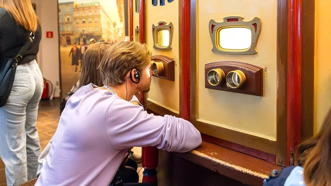 Visitor using audio guide at Oskar Schindler's Factory exhibit in Krakow, Poland.