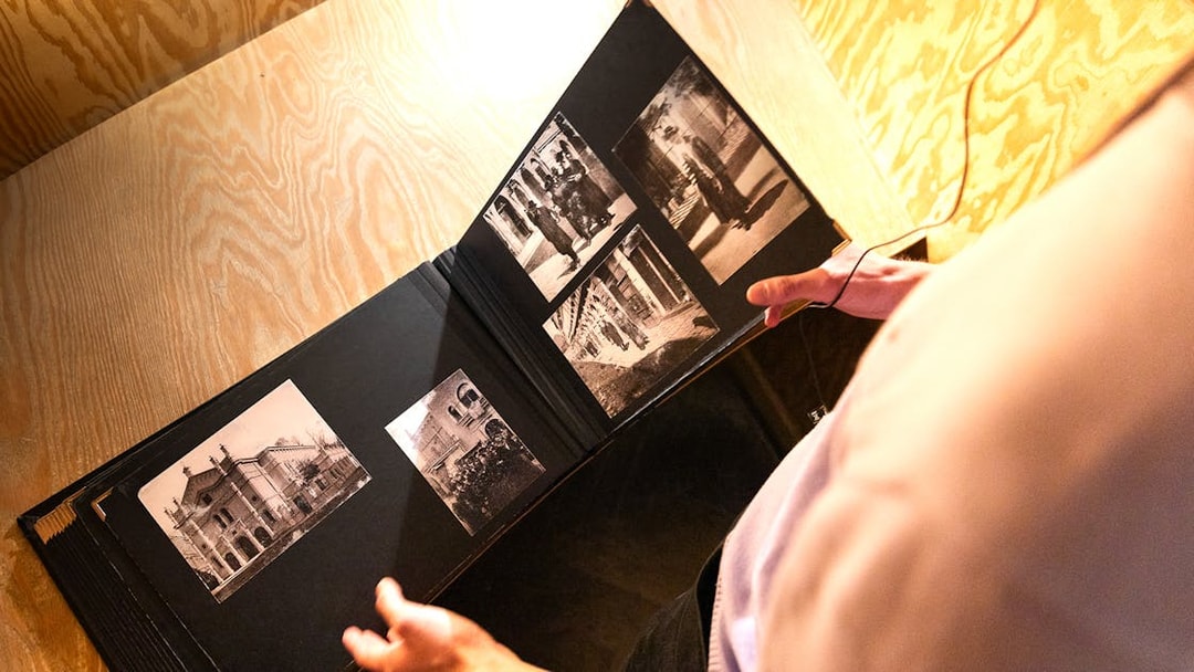 Photo album with historical images at Oskar Schindler's Factory entrance.