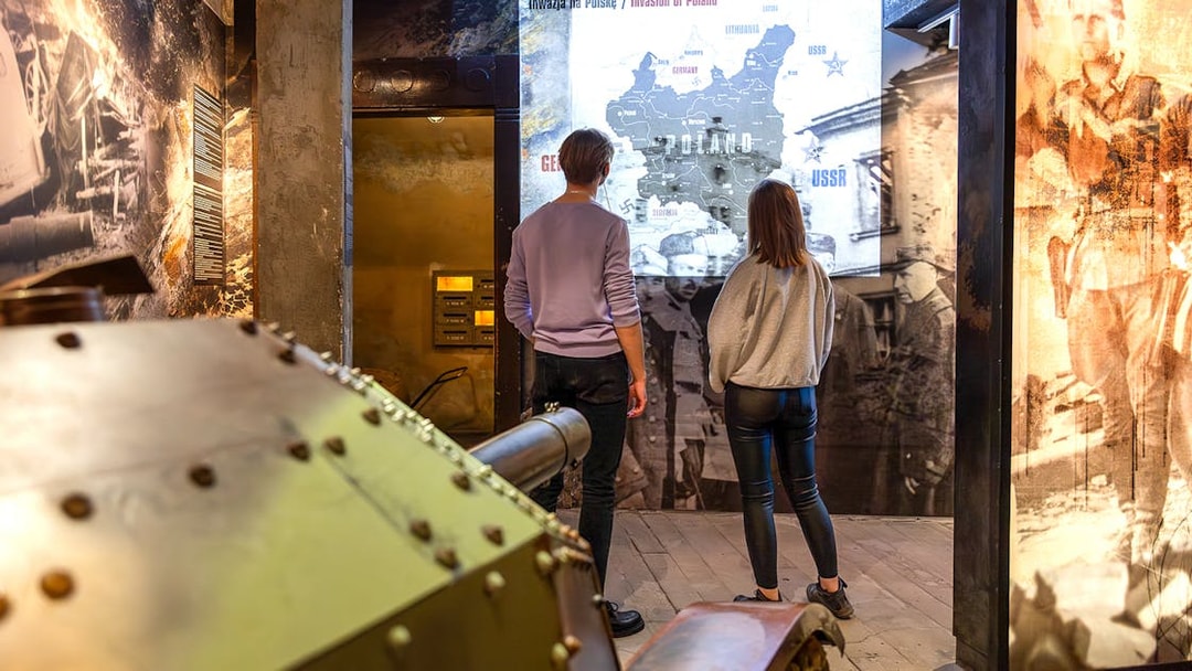 Visitors viewing historical exhibits at Oskar Schindler's Factory in Krakow, Poland.