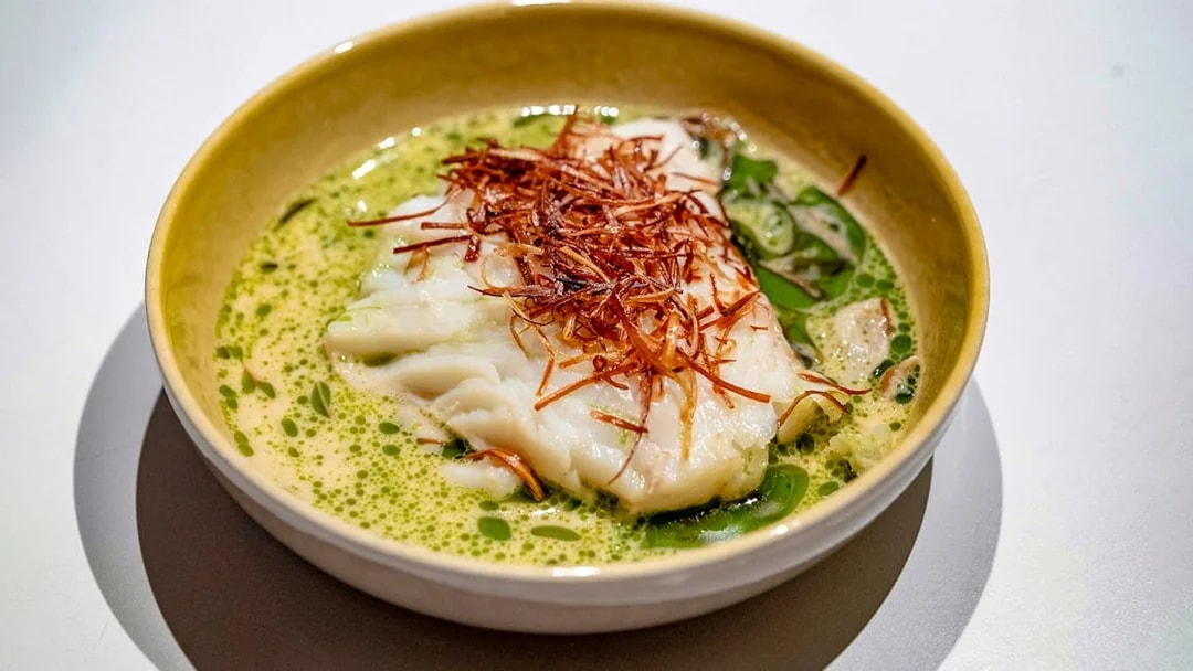 White fish dish with herbs served on Oslo dinner cruise.