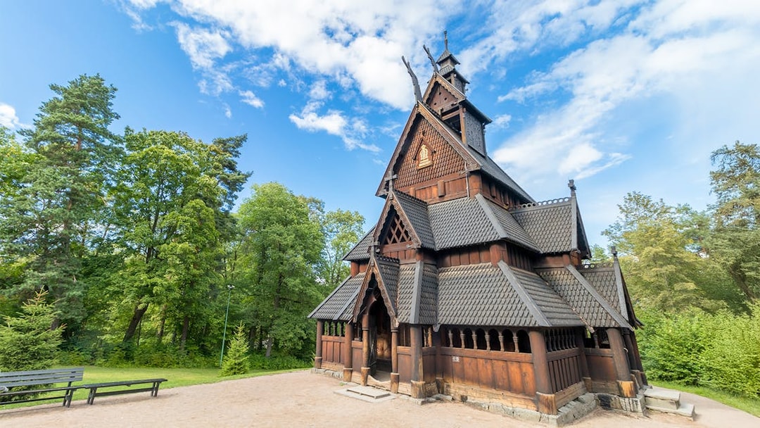 Stave church at the Norwegian Museum of Cultural History, Oslo, surrounded by trees.