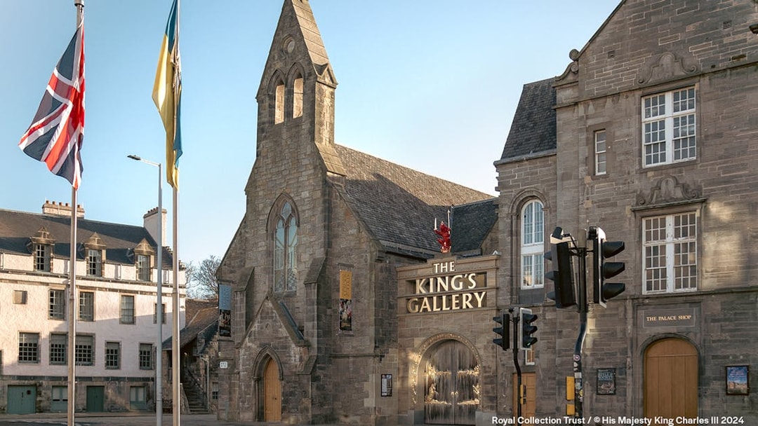 King's Gallery entrance at Palace of Holyroodhouse, Edinburgh, with flags and historic architecture.