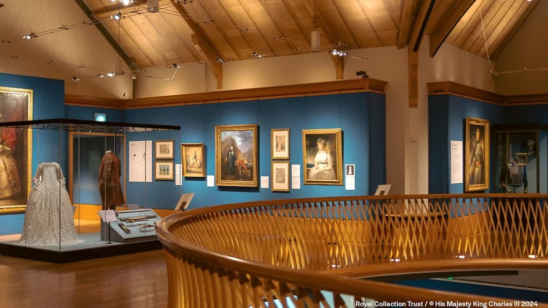 Museum gallery with historical paintings and period costumes on display.