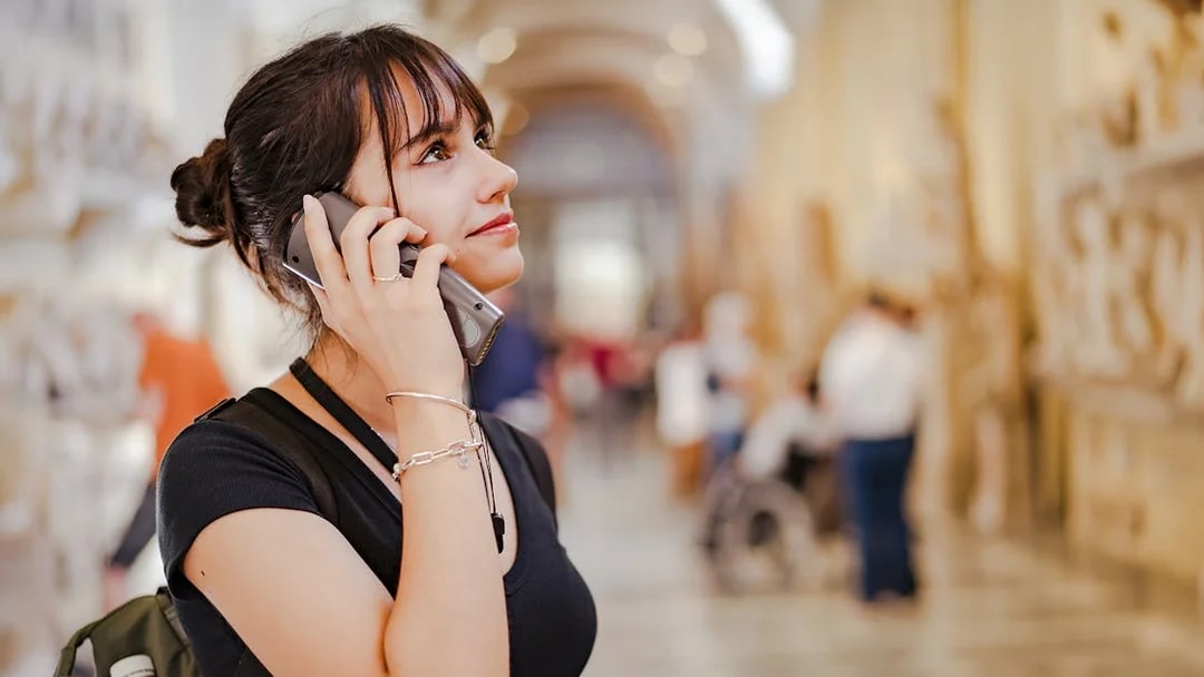 Woman using audio guide at Palace of Parliament.