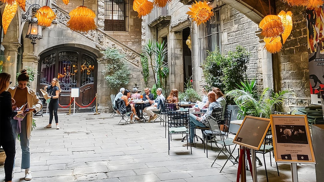 Courtyard at Palau Dalmases with people dining before a flamenco show in Barcelona.