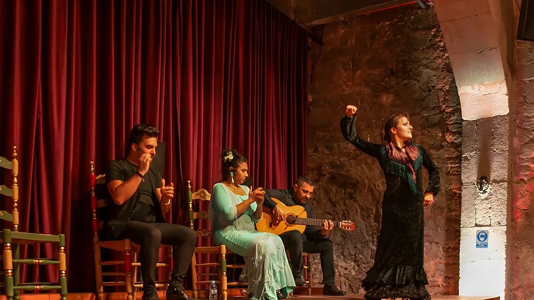 Flamenco performers on stage at Palau Dalmases, Barcelona.