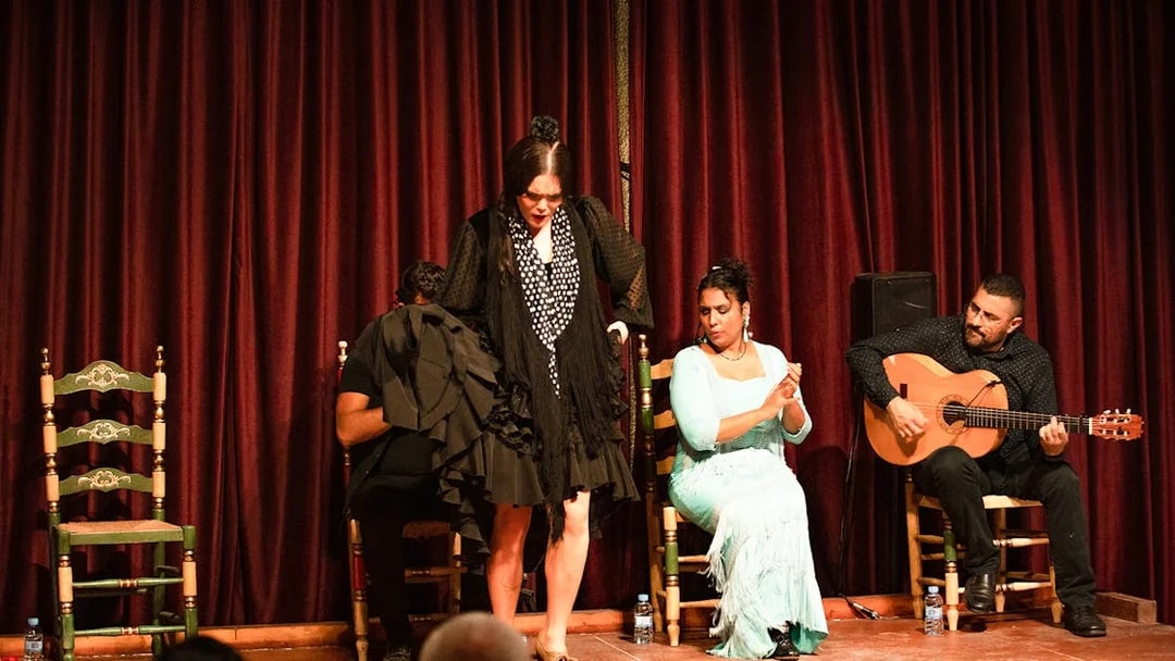 Flamenco dancer performing with musicians at Palau Dalmases, Barcelona.
