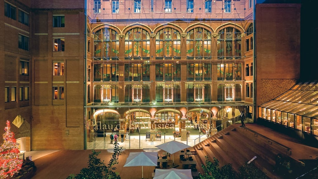 Palau de la Música Catalana entrance with illuminated facade in Barcelona.