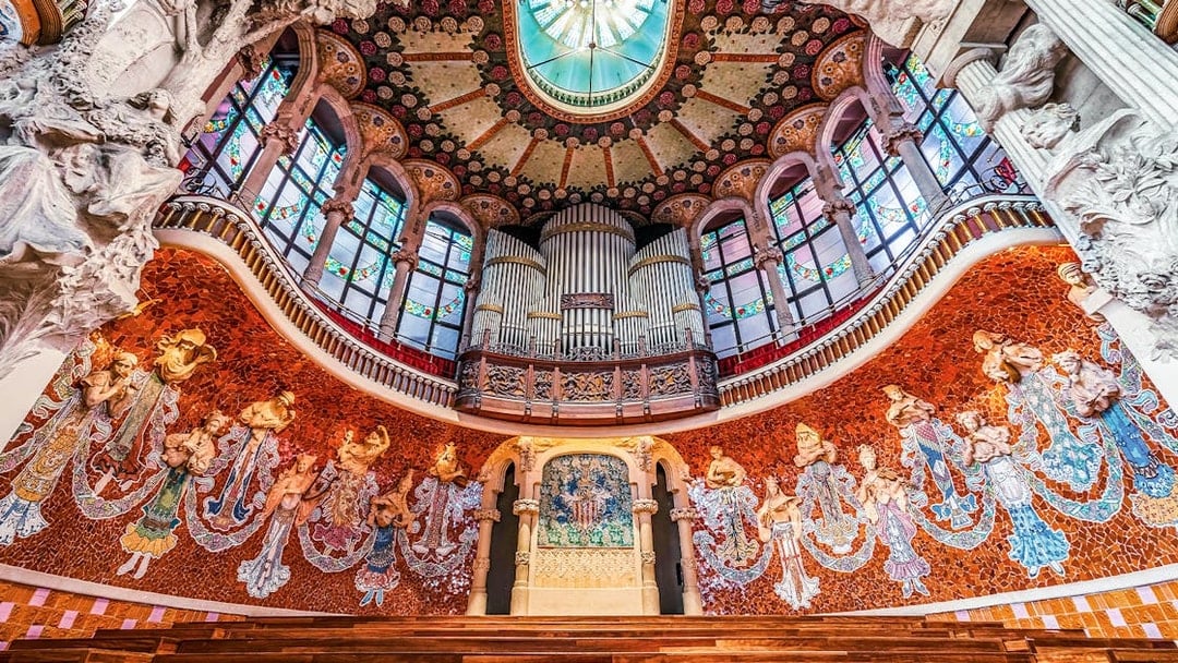 Wooden stage with stone relief and ornate organ inside Palau de la Musica Catalana, Barcelona.