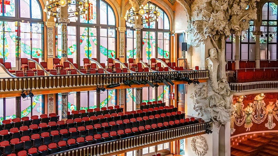 Interior of Palau de la Música Catalana with stained glass windows and ornate sculptures, Barcelona.