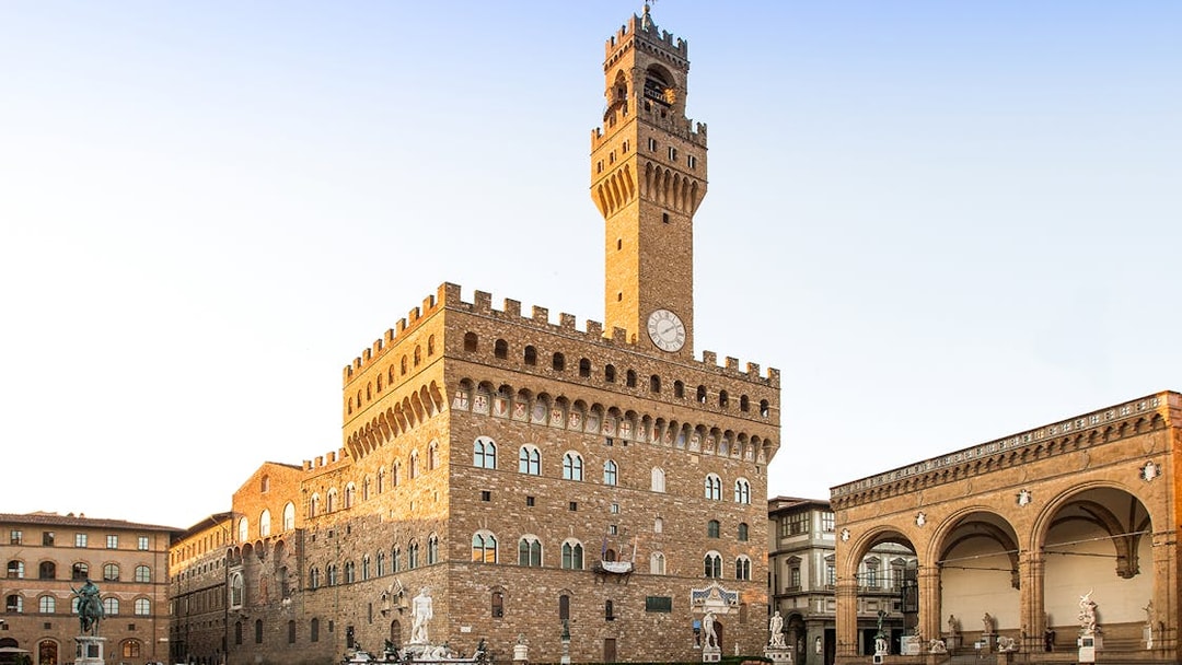 Palazzo Vecchio exterior view with clock tower in Florence, Italy.