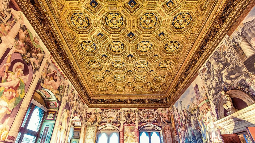 Palazzo Vecchio ornate ceiling and frescoes during skip-the-line guided tour in Florence, Italy.