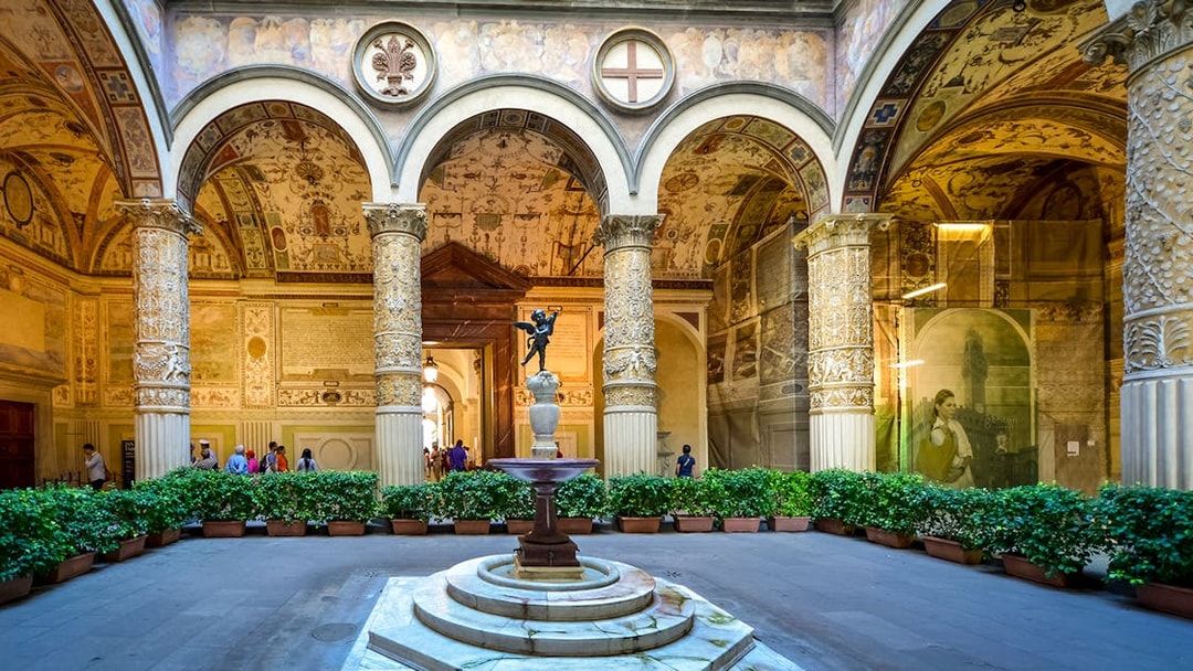 Palazzo Vecchio Museum courtyard with ornate columns and fountain, Florence.