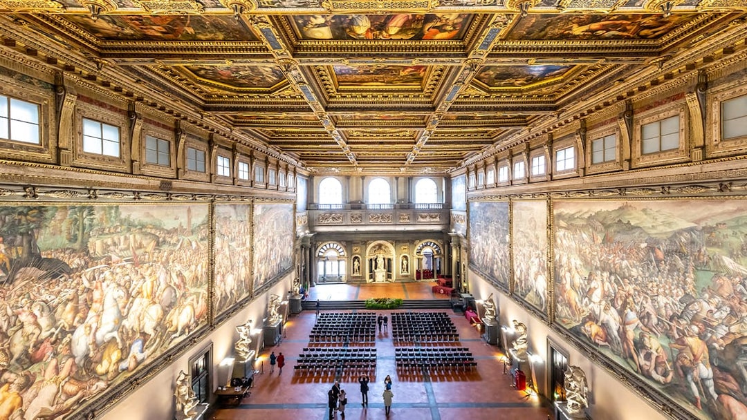 Palazzo Vecchio Hall of the Five Hundred with ornate ceiling and historic frescoes, Florence, Italy.