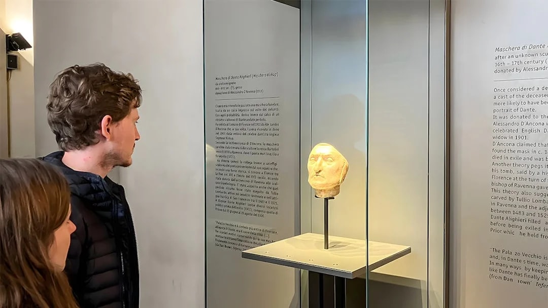 Tourists viewing Dante's death mask exhibit at Palazzo Vecchio, Florence.