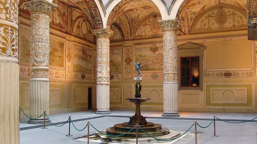 Palazzo Vecchio courtyard with ornate columns and central fountain in Florence, Italy.