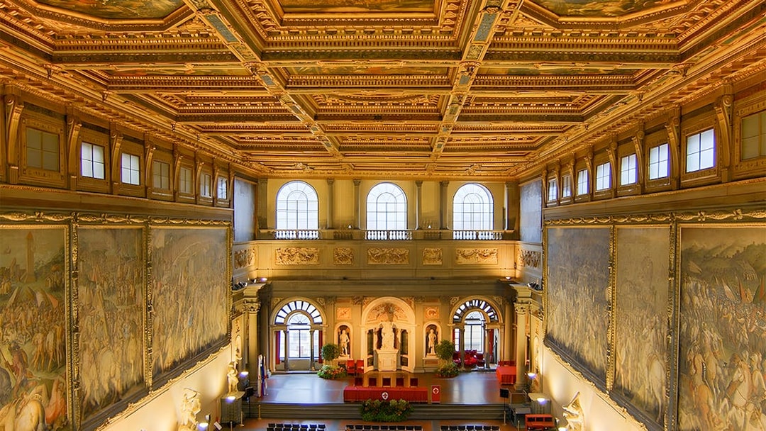 Palazzo Vecchio interior with ornate ceiling and large frescoes, Florence, Italy.
