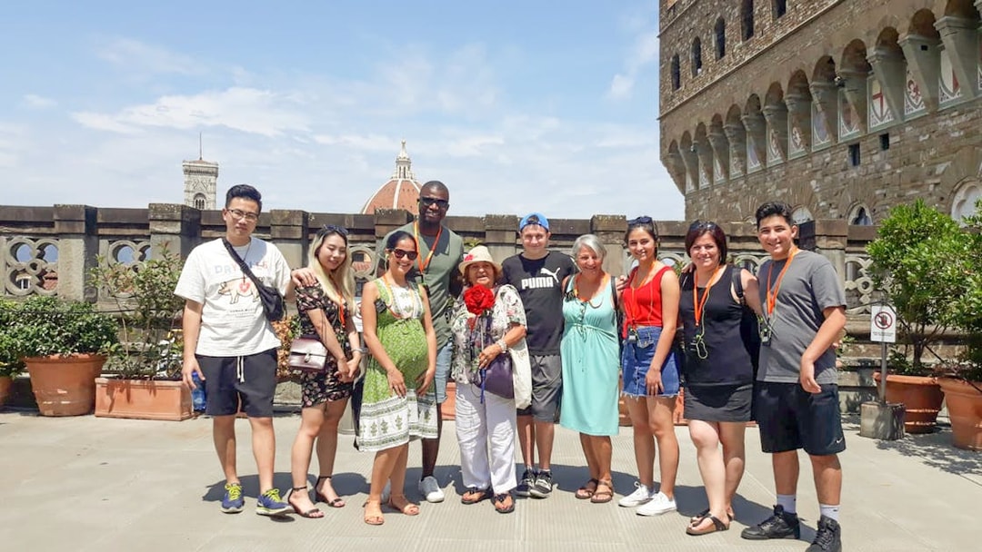 Group of tourists on a Palazzo Vecchio tour in Florence, Italy, with the Duomo in the background.