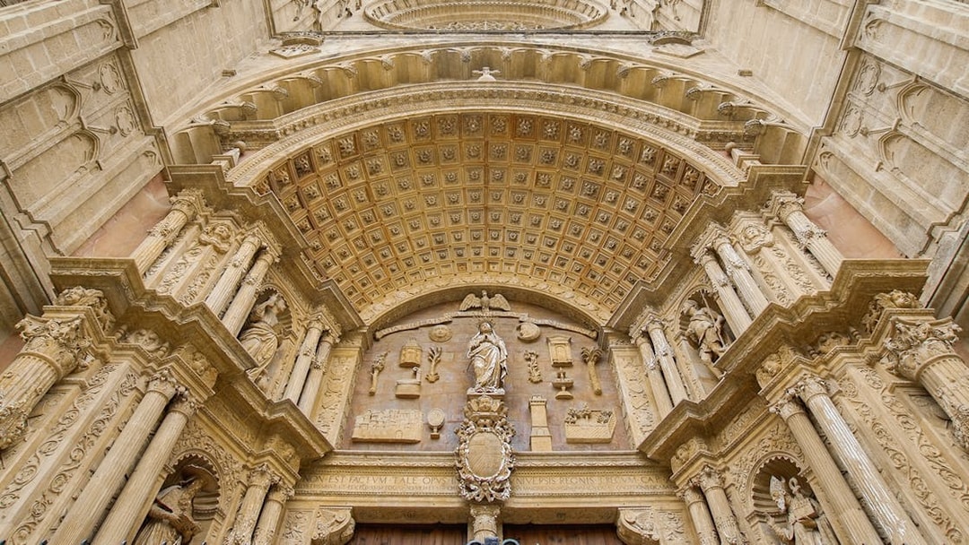 Mallorca Cathedral entrance with ornate carvings and statues.