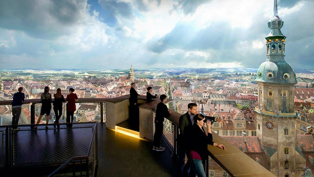 Visitors observing Dresden cityscape from Panometer viewing platform.