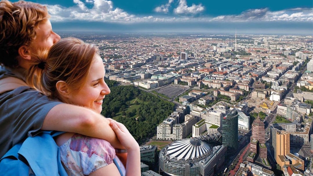 Couple enjoying city view from Panoramapunkt Berlin with skyline and Sony Center.