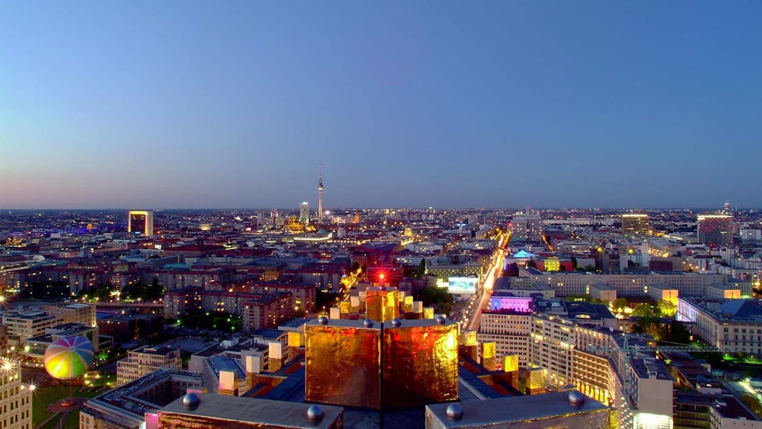 Berlin cityscape view from Panoramapunkt at dusk, featuring the TV Tower and illuminated streets.