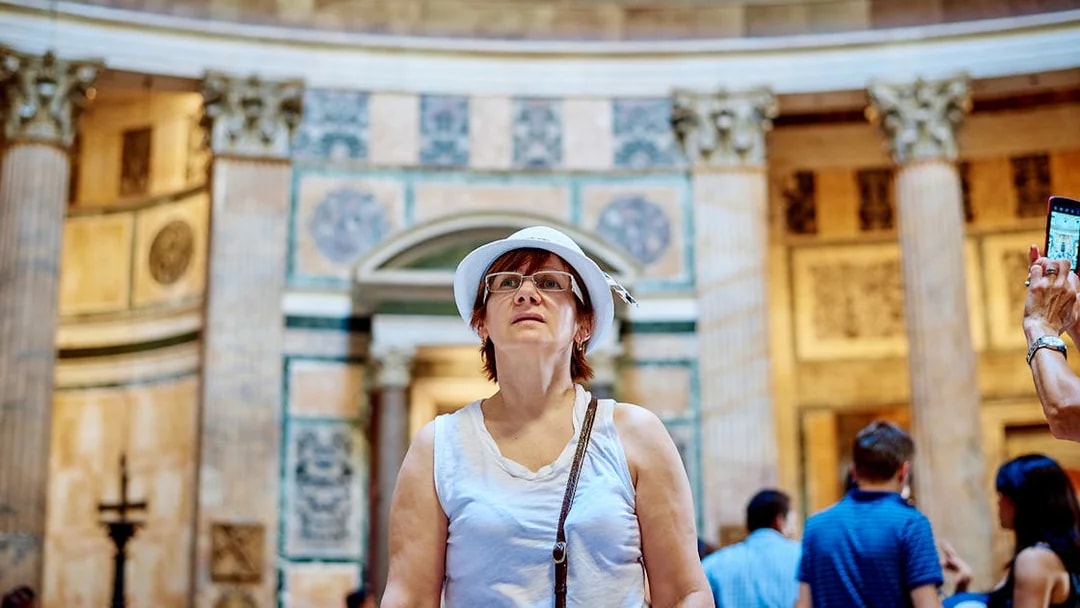 Visitor exploring the interior of the Pantheon during a guided tour in Rome.