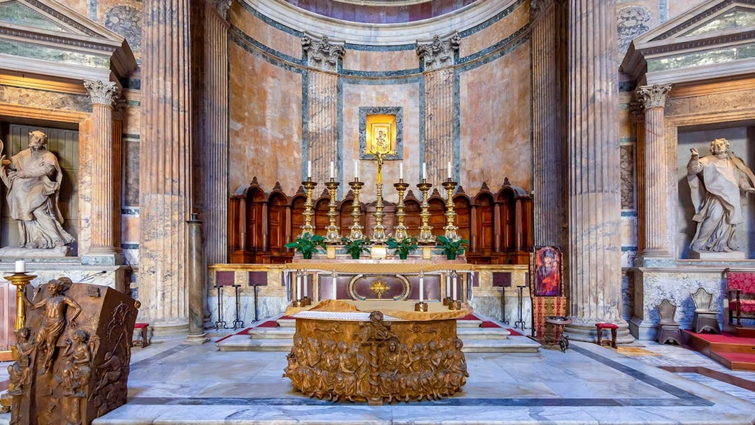 Main altar of the Pantheon in Rome with ornate carvings and golden candlesticks.