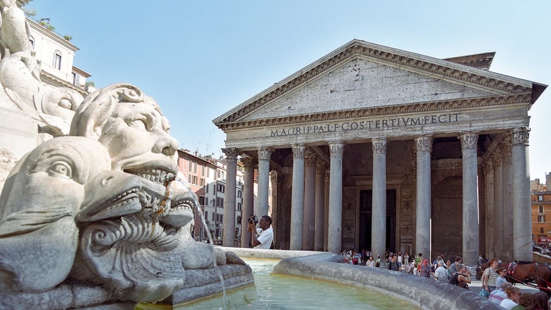 Pantheon entrance with fountain in foreground, Rome, during guided tour.