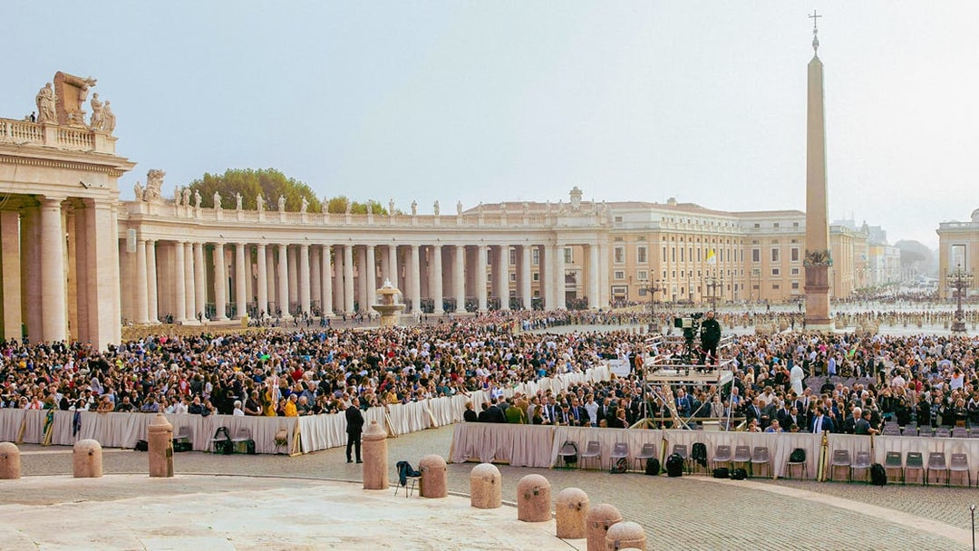 Crowd gathered at St. Peter's Square, Vatican City, for a mass event.
