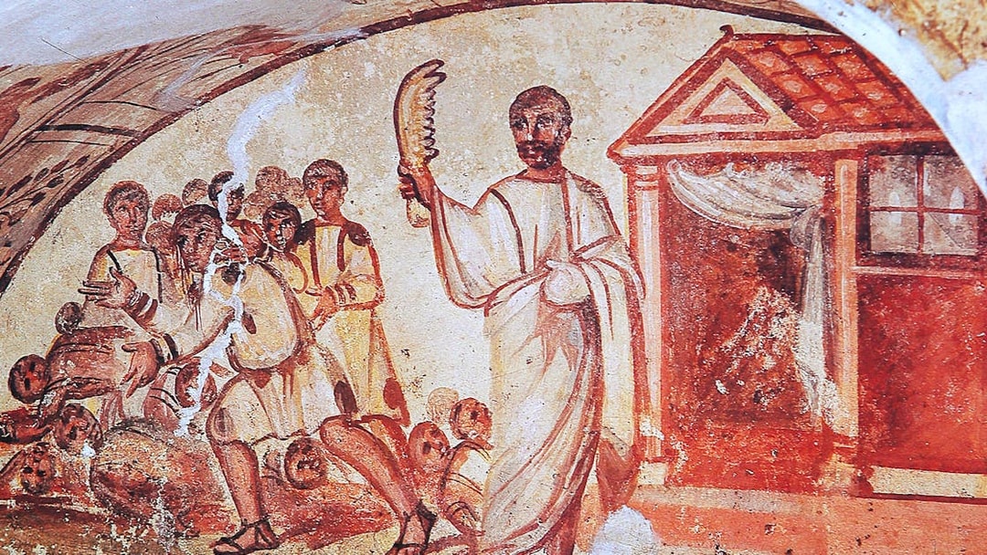 Ancient fresco depicting figures in Roman attire inside catacombs on the Appian Way, Rome.