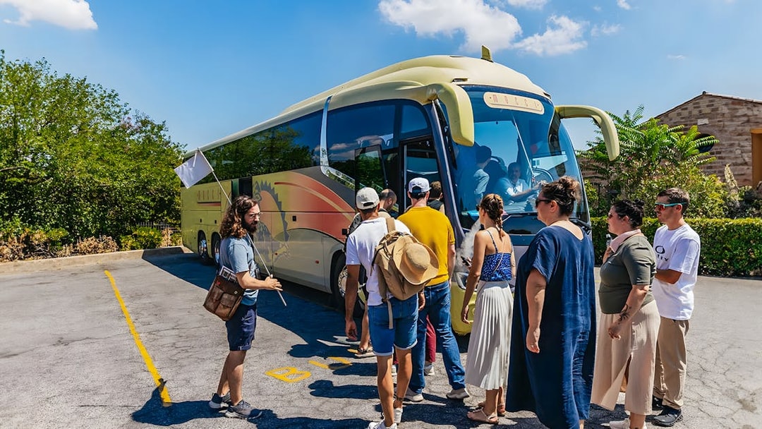 Tour group boarding bus for Roman Basilicas & Catacombs tour on Appian Way.