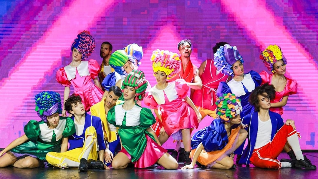 Performers in colorful costumes on stage during Paris: My First Cabaret show.