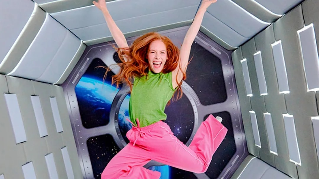 Guest jumping in space-themed room at Paradox Museum London.