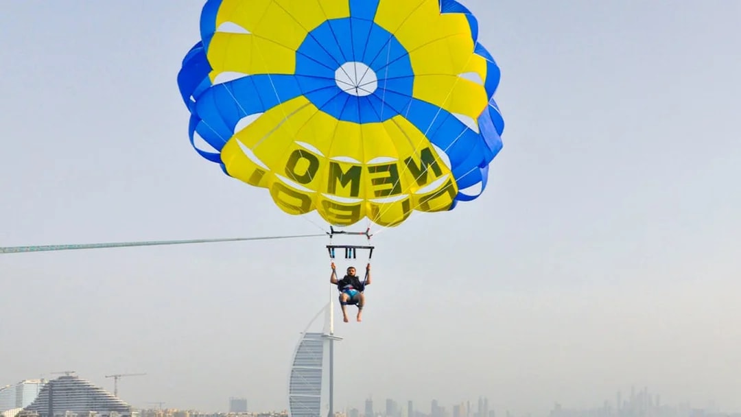 Parasailing over Dubai with Burj Al Arab in the background.