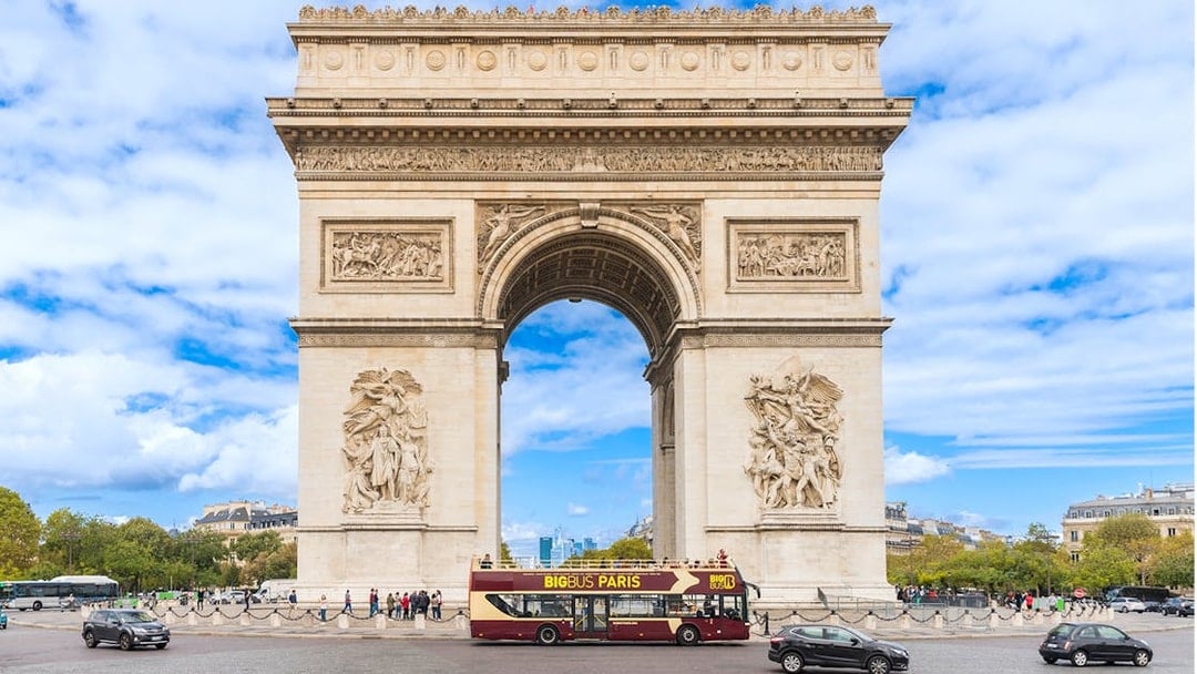 Big Bus tour passing by the Arc de Triomphe in Paris.