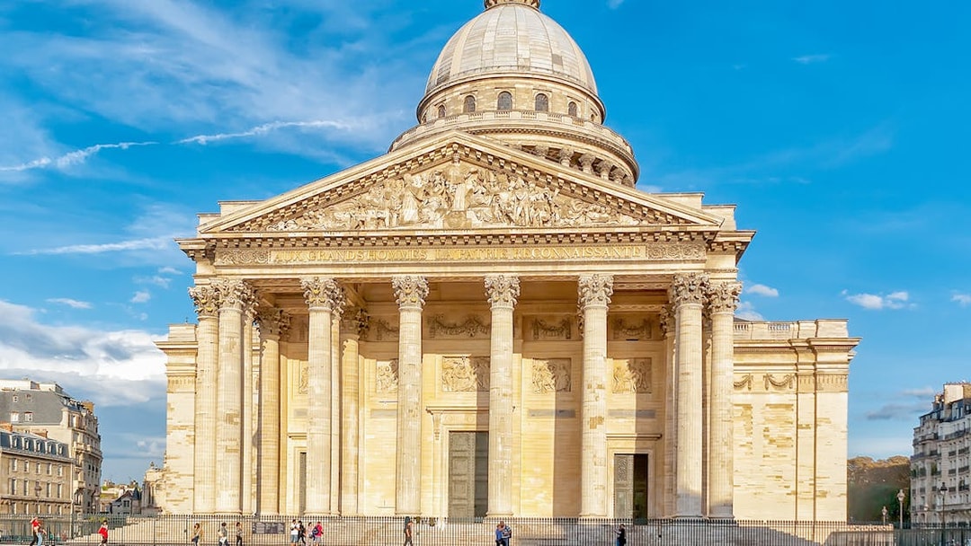 Pantheon entrance in Paris with tourists exploring the historic site.