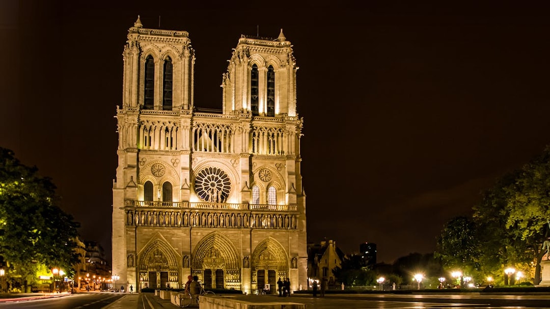 Notre-Dame Cathedral illuminated at night, Paris city tour.