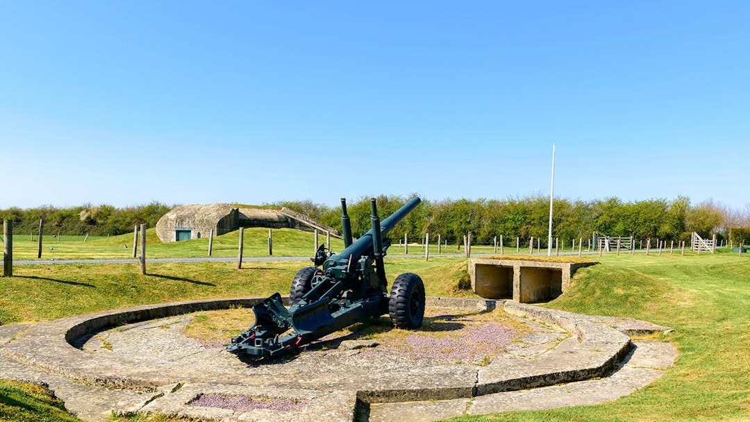 Normandy D-Day site with artillery gun and bunker, France.