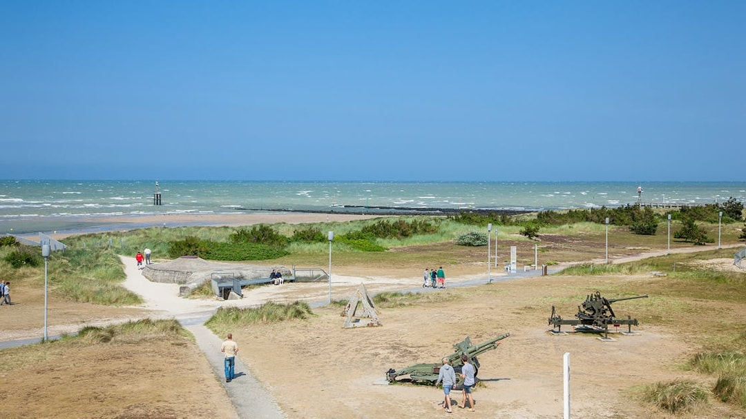 Normandy beach with WWII bunkers and artillery, part of D-Day tour from Paris, Canada sector.