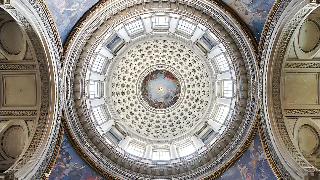 Dome interior of the Paris Pantheon with intricate frescoes and architectural details.